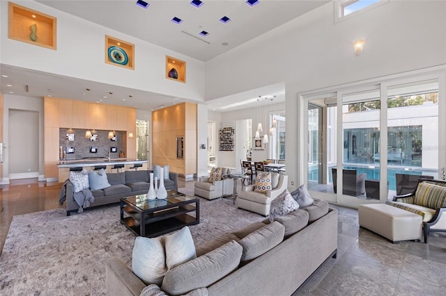 tiled living room featuring a high ceiling