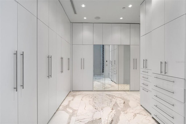 walk in closet featuring light tile floors