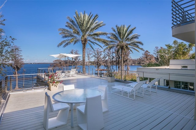 wooden deck with a water view and grilling area