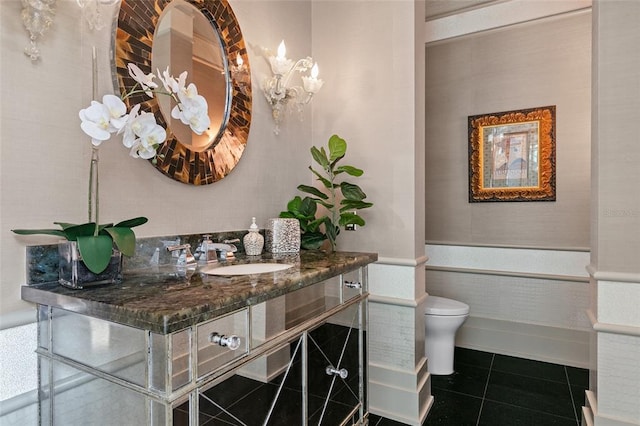 bathroom with tile floors, toilet, and vanity