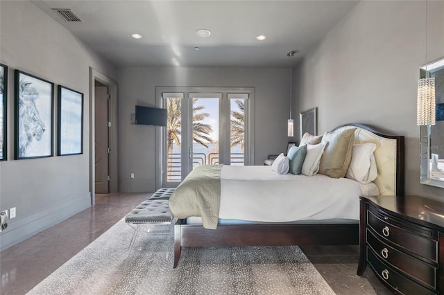 bedroom featuring dark tile flooring and access to outside