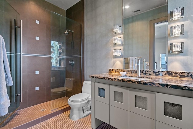 bathroom featuring an enclosed shower, vanity, tile flooring, and toilet