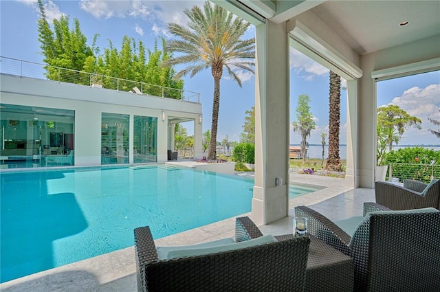 view of pool featuring an outdoor living space and a patio area