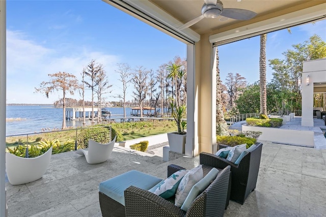 view of patio featuring a water view, outdoor lounge area, and ceiling fan