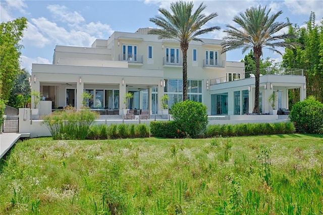 rear view of property featuring a yard