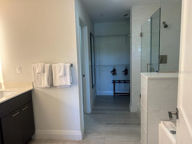 bathroom with vanity and a shower with door