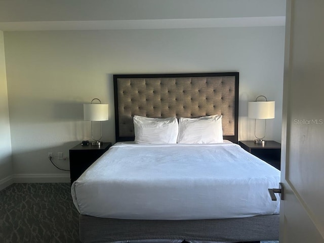 bedroom featuring dark colored carpet