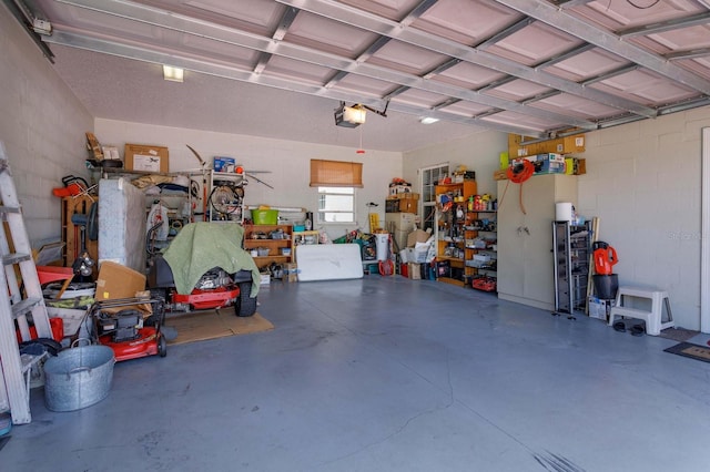 garage with concrete block wall and a garage door opener