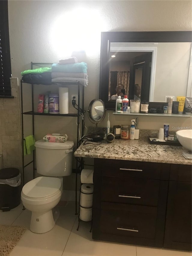 bathroom with tile patterned flooring, vanity, and toilet