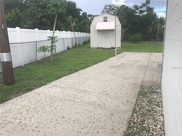 view of yard with a shed and a patio