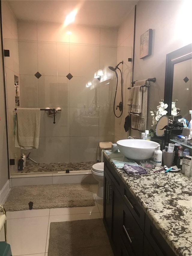 full bath featuring a stall shower, vanity, toilet, and tile patterned floors