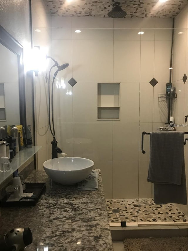 full bathroom with a stall shower and vanity