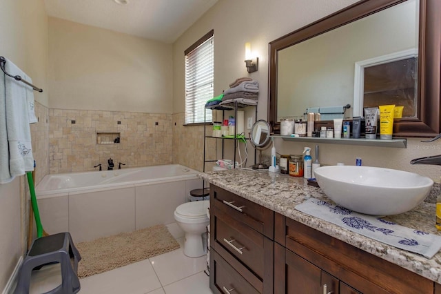 bathroom featuring vanity, tiled bath, tile patterned floors, and toilet