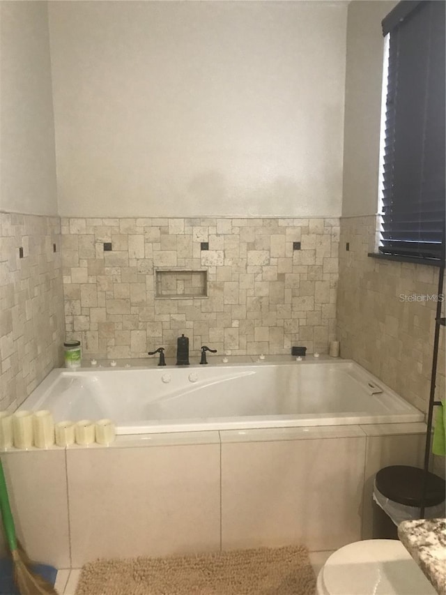 full bathroom with toilet and a bath