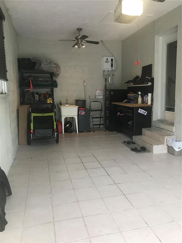 interior space featuring light tile patterned floors and a ceiling fan