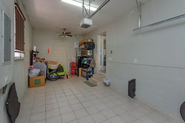 garage with concrete block wall and a garage door opener