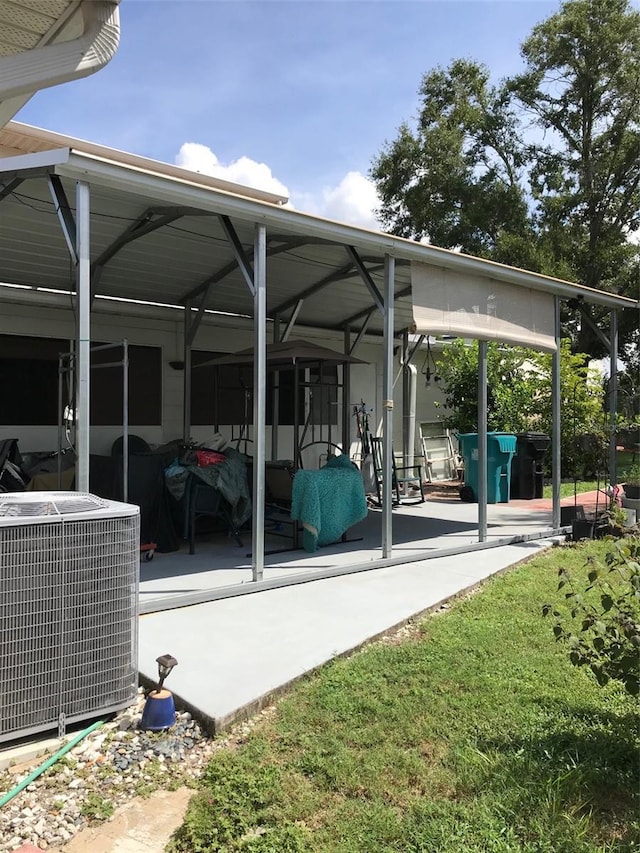 view of patio featuring central AC and a detached carport