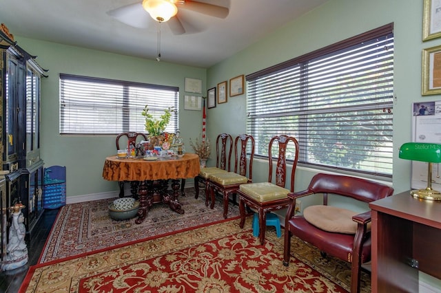 office space with baseboards, a ceiling fan, and wood finished floors