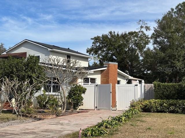 view of side of property featuring a gate and fence