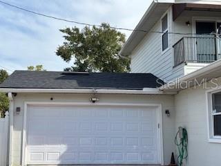 exterior space featuring a balcony and a garage