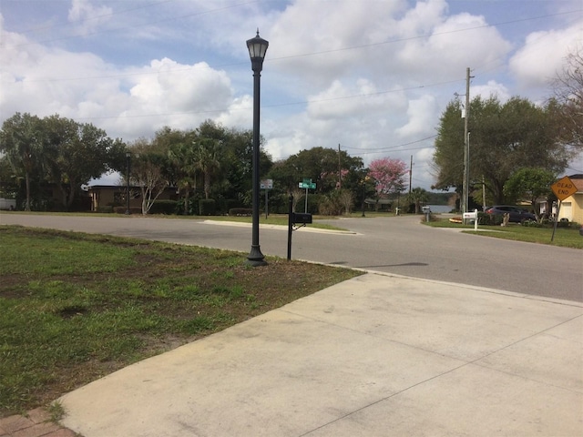 view of street featuring street lighting and traffic signs