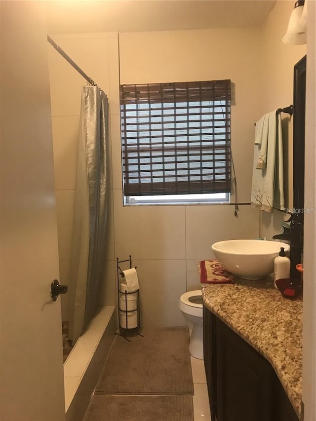 bathroom featuring a shower with curtain, tile patterned flooring, vanity, and toilet