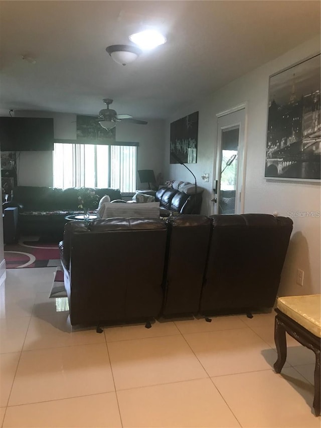 living room with ceiling fan and tile patterned floors