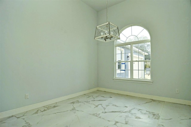 spare room with vaulted ceiling and an inviting chandelier