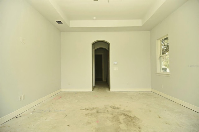 unfurnished room with a raised ceiling