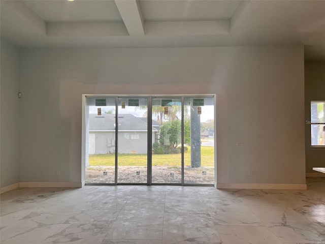 spare room featuring a high ceiling and beam ceiling