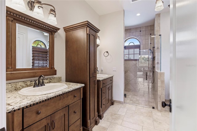 bathroom featuring an enclosed shower, dual vanity, and tile floors