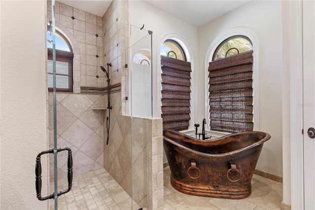 bathroom featuring separate shower and tub