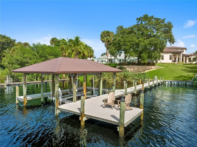 dock area featuring a lawn and a water view