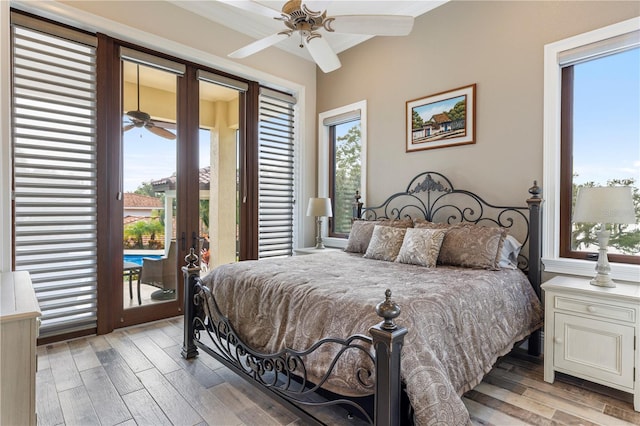 bedroom with ceiling fan, access to outside, light wood-type flooring, and french doors