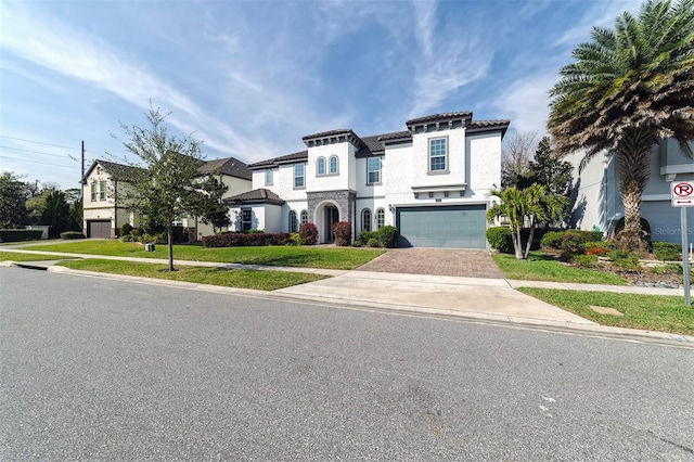 mediterranean / spanish house with a front yard and a garage