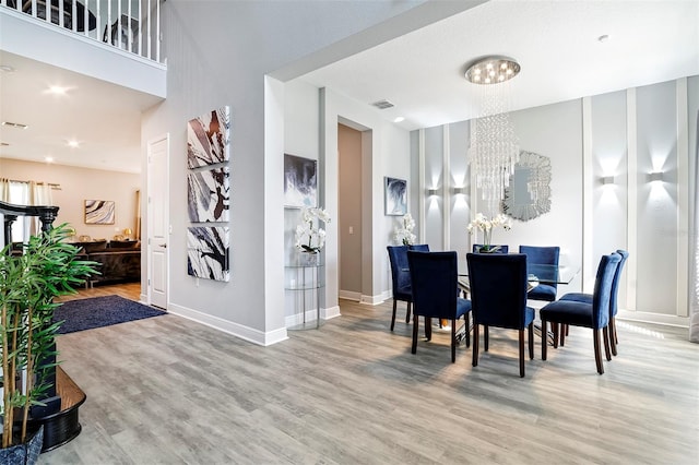 dining room featuring light hardwood / wood-style floors and a chandelier