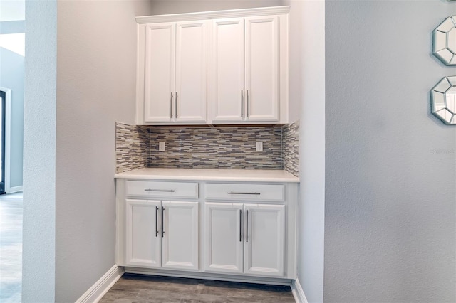 kitchen featuring white cabinets, tasteful backsplash, and light wood-type flooring