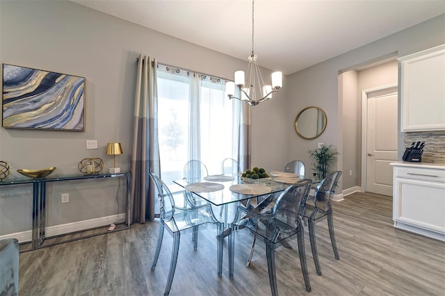 dining room featuring light hardwood / wood-style floors and an inviting chandelier