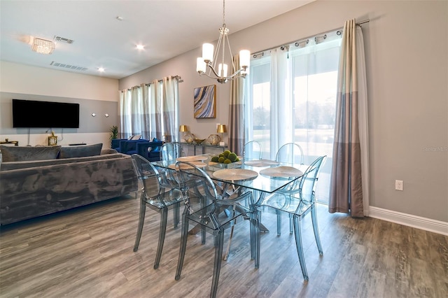 dining room with an inviting chandelier, hardwood / wood-style floors, and a healthy amount of sunlight