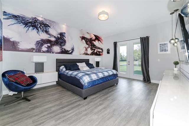 bedroom with access to exterior, light wood-type flooring, and french doors