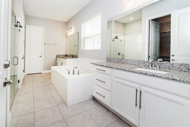 bathroom with oversized vanity, plus walk in shower, and tile flooring