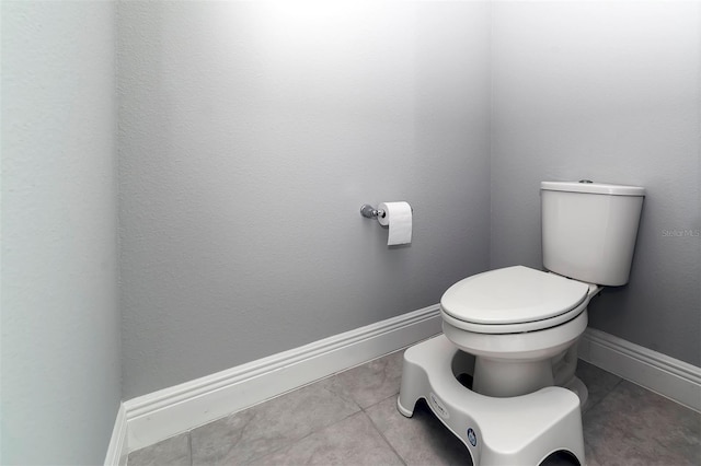 bathroom featuring toilet and tile flooring