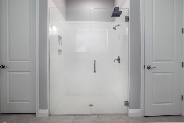 bathroom featuring an enclosed shower and tile floors