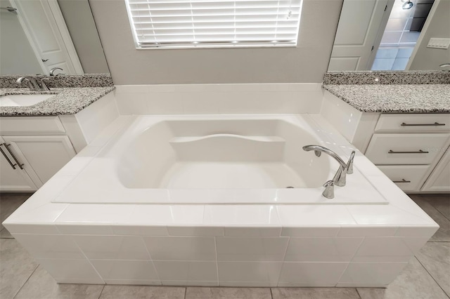 bathroom featuring tile floors, vanity, and a relaxing tiled bath