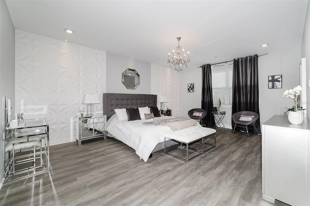 bedroom with a notable chandelier and wood-type flooring