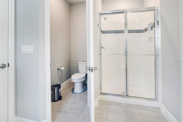 bathroom with an enclosed shower, tile floors, and toilet