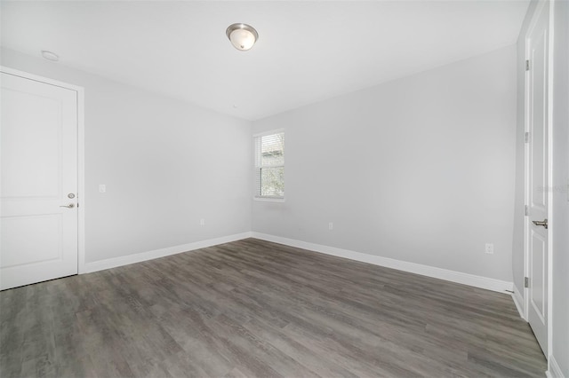 spare room with dark hardwood / wood-style floors