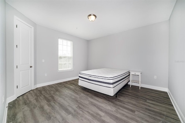 unfurnished bedroom with dark wood-type flooring