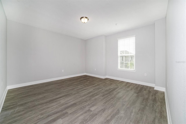 empty room with dark wood-type flooring