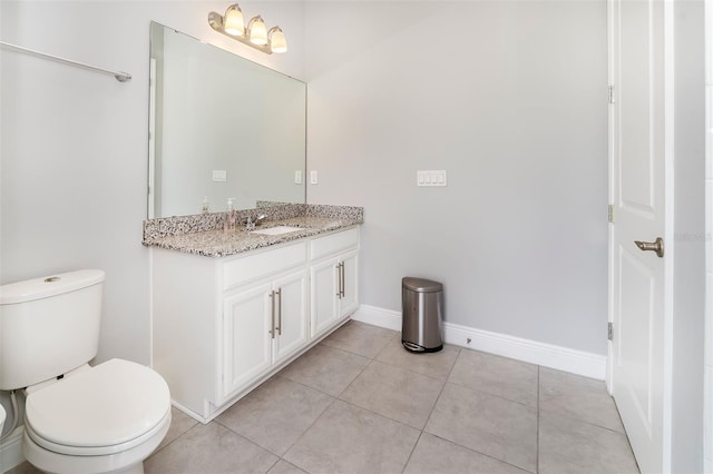 bathroom with tile flooring, oversized vanity, and toilet